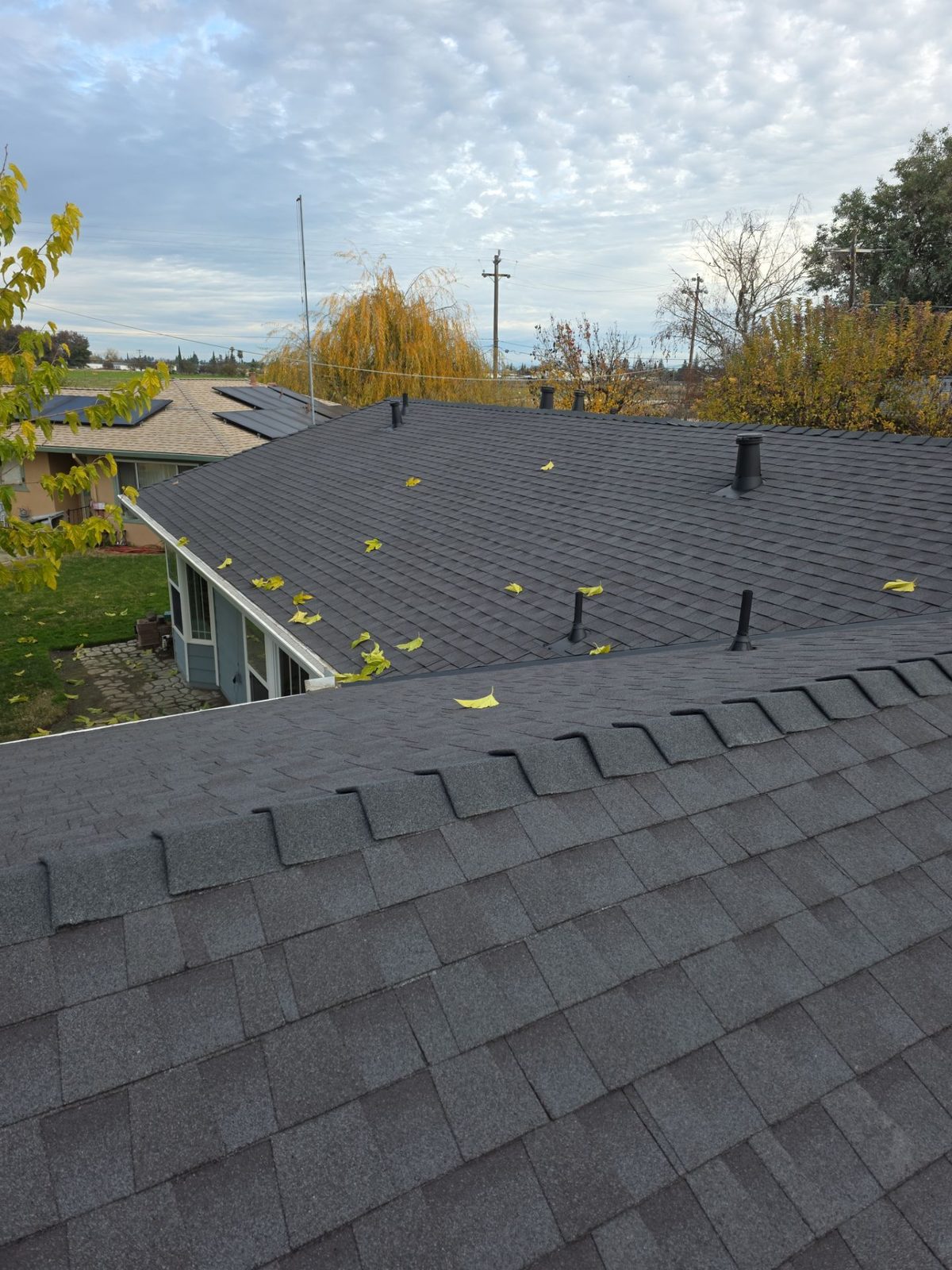 Completed dark architectural shingle roof on the Atwater home after replacement