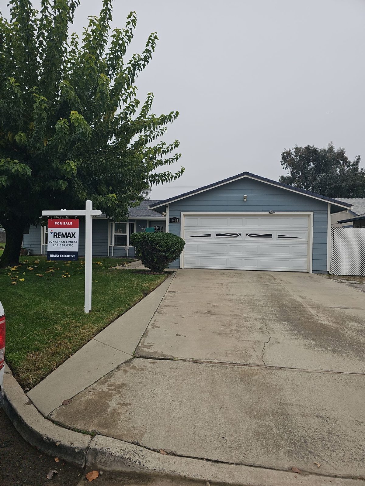 Atwater home at 3484 Virginia St with a FOR SALE sign before roof replacement