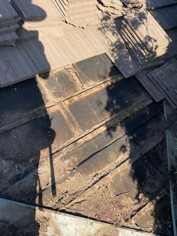 Damaged concrete tile roof before repair in Riverbank, CA
