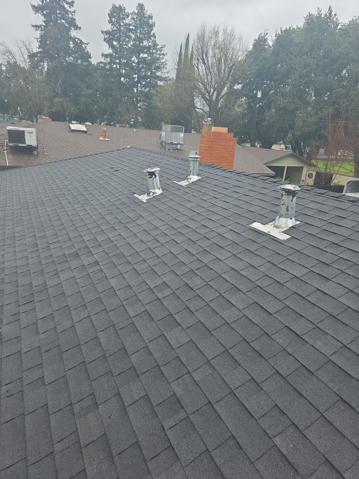 Aerial view of the completed architectural shingle roof on the Turlock home
