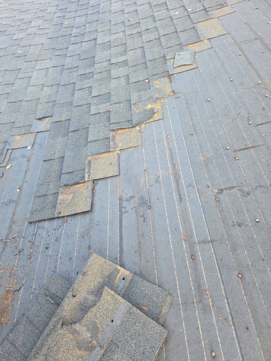 Old composition shingles being torn off down to the deck at 1875 Charles Place Turlock
